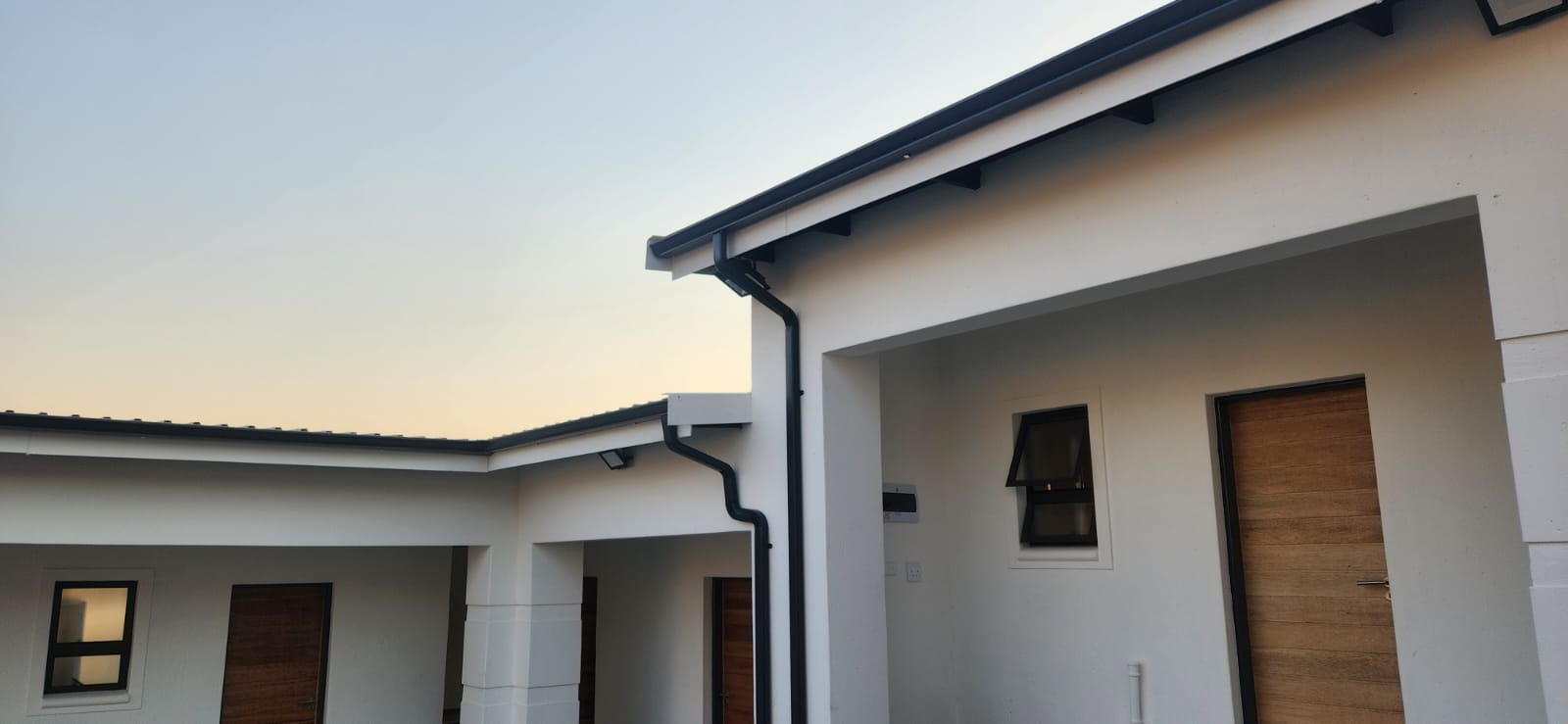 Seamless gutter run installed along the edge of a domestic roof